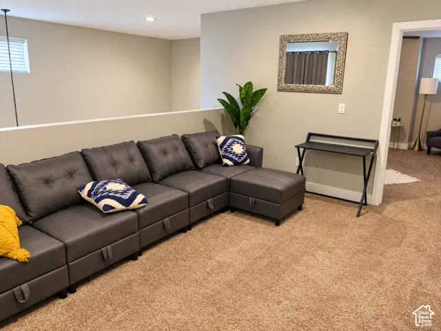 Neutral-toned interior featuring wall-to-wall carpeting, recessed ceiling lighting, and a half-wall partition
