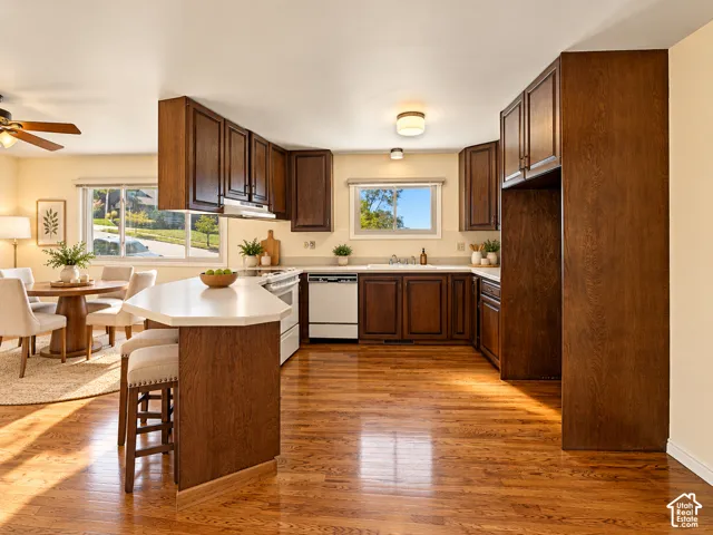 Kitchen featuring wood-finish cabinetry, light-toned countertops, and stainless-steel appliances