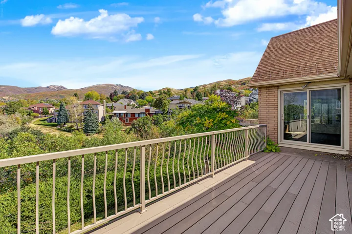 Elevated deck with composite plank flooring and decorative railing