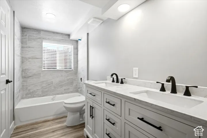 Dual sink vanity with white cabinetry and dark hardware