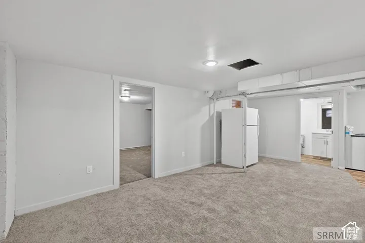 Recessed ceiling lighting, exposed ceiling ductwork, and plush carpeting