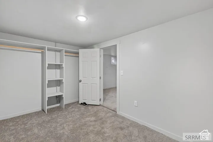 Recessed lighting, wall-to-wall carpeting, and a built-in closet system with shelving