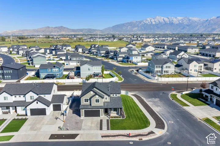 Modern residential neighborhood featuring a variety of home styles, expansive paved roadways, and manicured green spaces