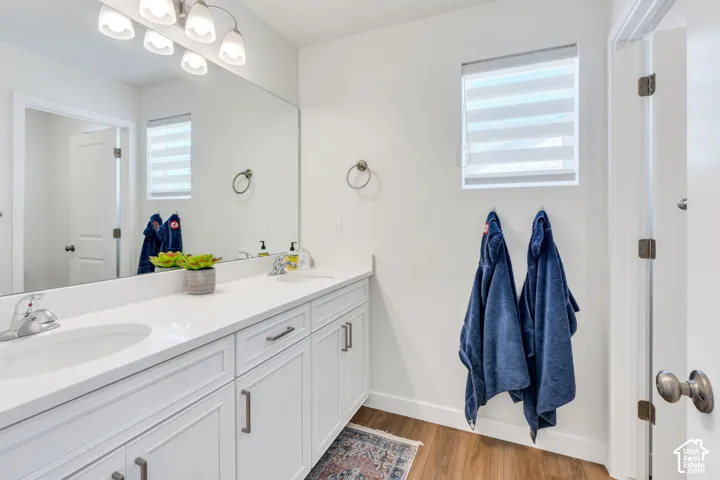 Double vanity with integrated sinks and white cabinetry