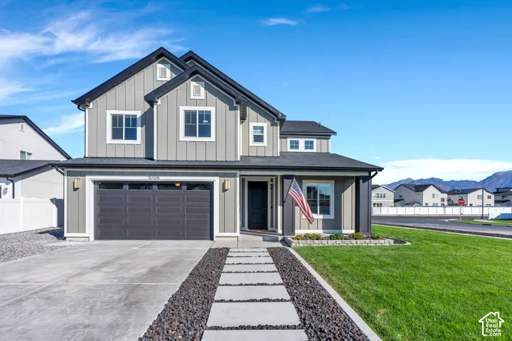 Modern farmhouse-style exterior with gray vertical siding and white trim