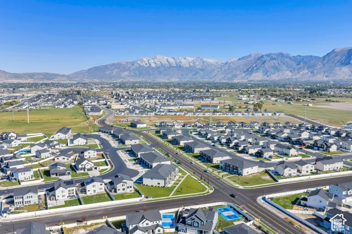 Mountain range backdrop with a residential community, featuring multiple detached homes and townhomes