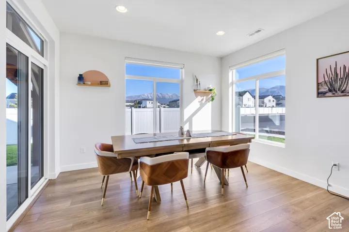 Wood-finish flooring, recessed lighting, and expansive windows