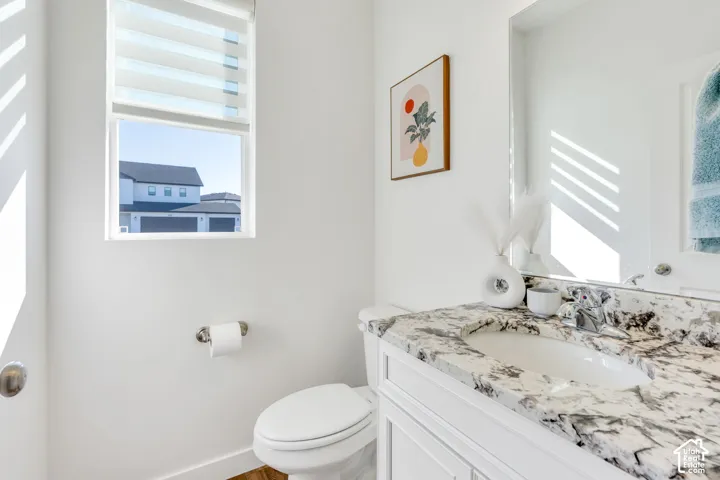 White vanity with an integrated sink and a stone countertop