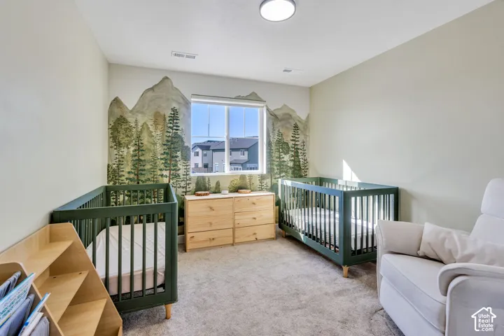 Light-colored carpeted flooring, window with exterior views, recessed lighting, and painted wall mural