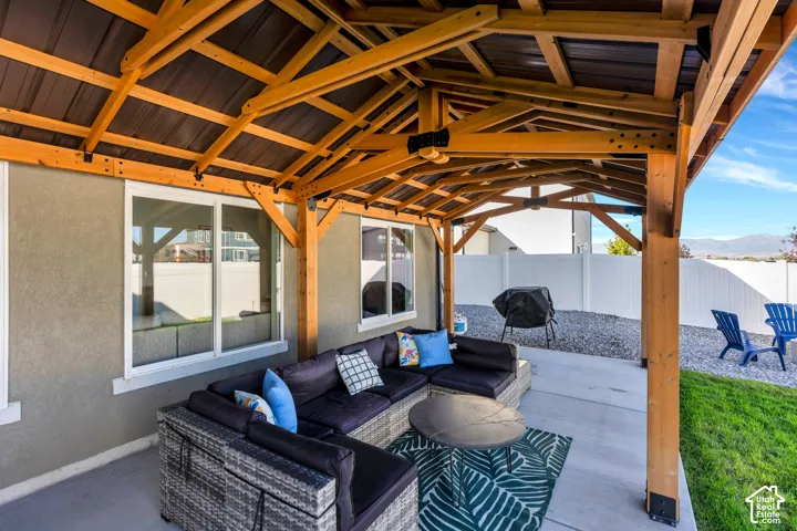 Covered patio with exposed wood beam ceiling and metal roof