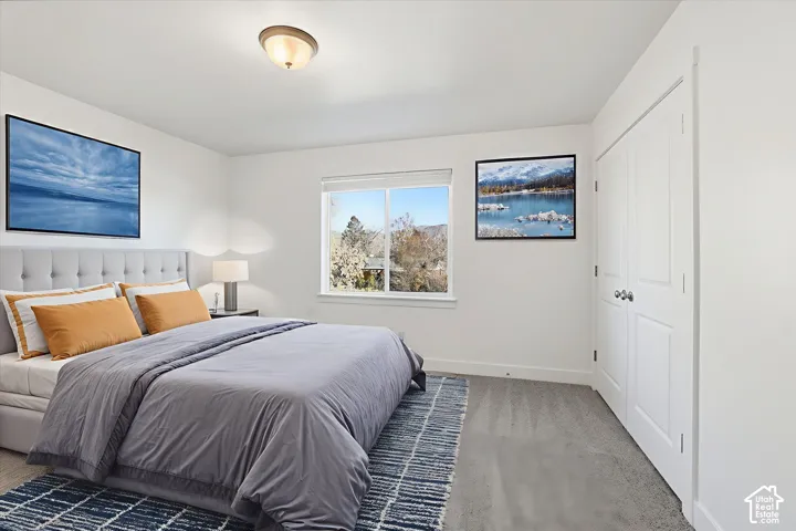 White walls with a window, semi-flush mount ceiling light, and bi-fold closet doors