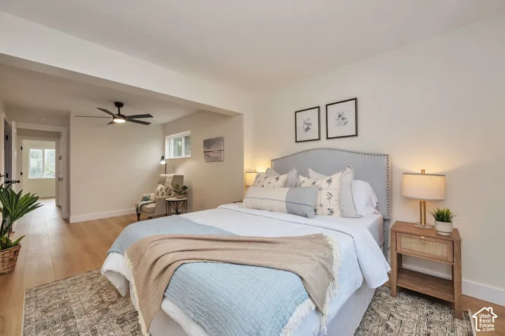 Wood-finish flooring, recessed lighting, and a ceiling fan with integrated lighting