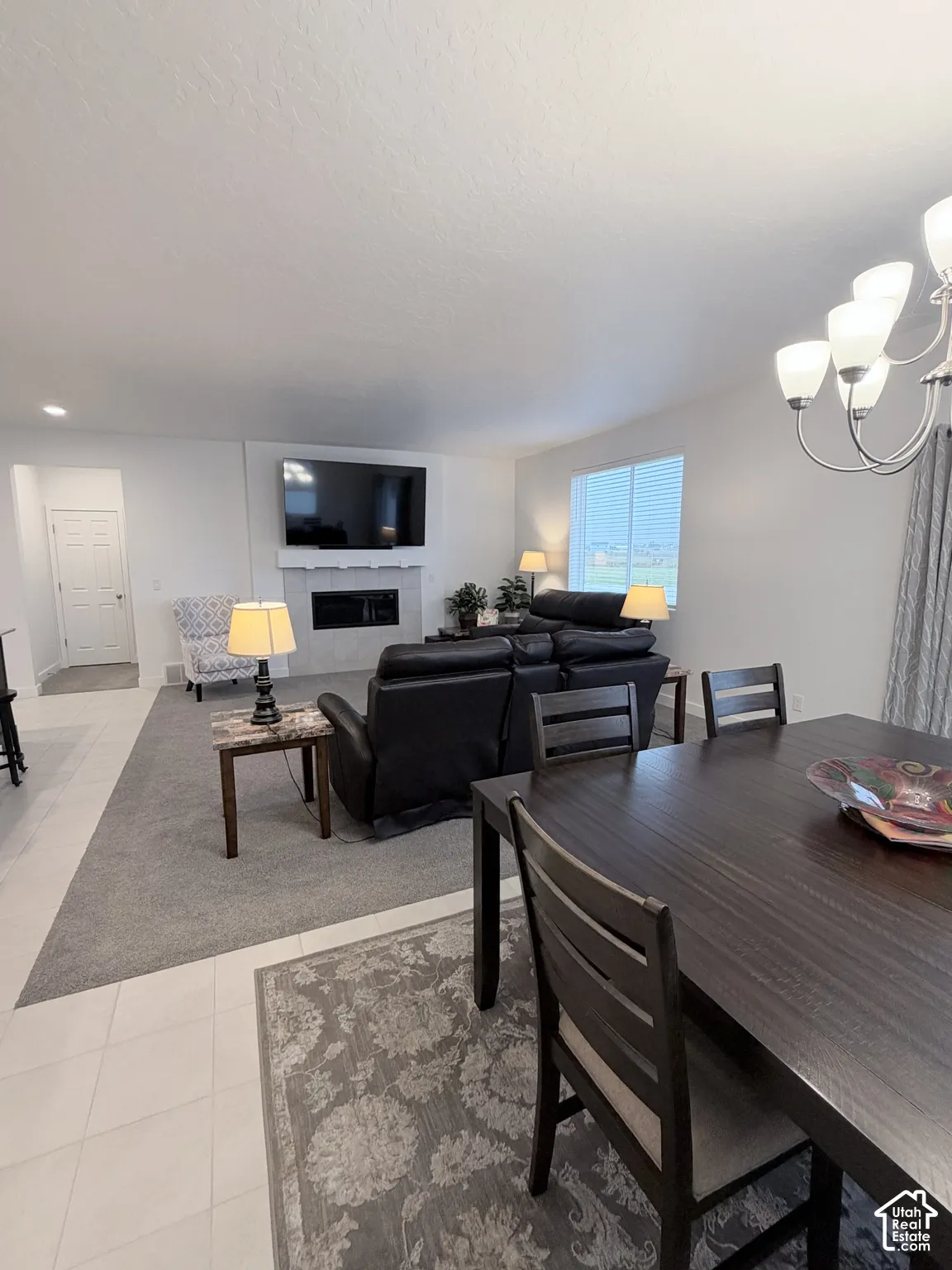 Recessed lighting, fireplace with mantel, window blinds, tile flooring, and carpeted living area