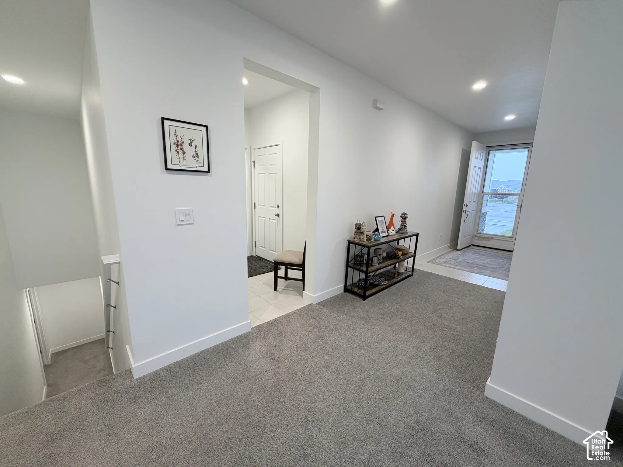 Recessed ceiling lighting, light gray wall paint, and white trim