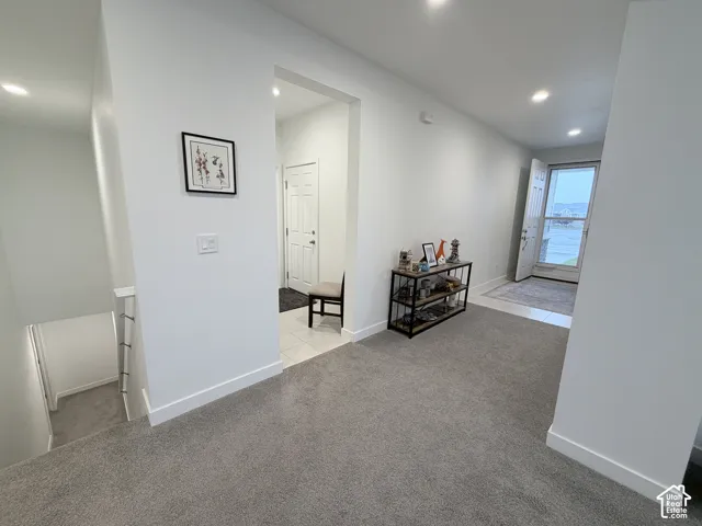 Recessed ceiling lighting, light gray wall paint, and white trim