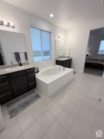 Dual vanity with granite countertops, undermount sinks, and dark wood-finish cabinetry
