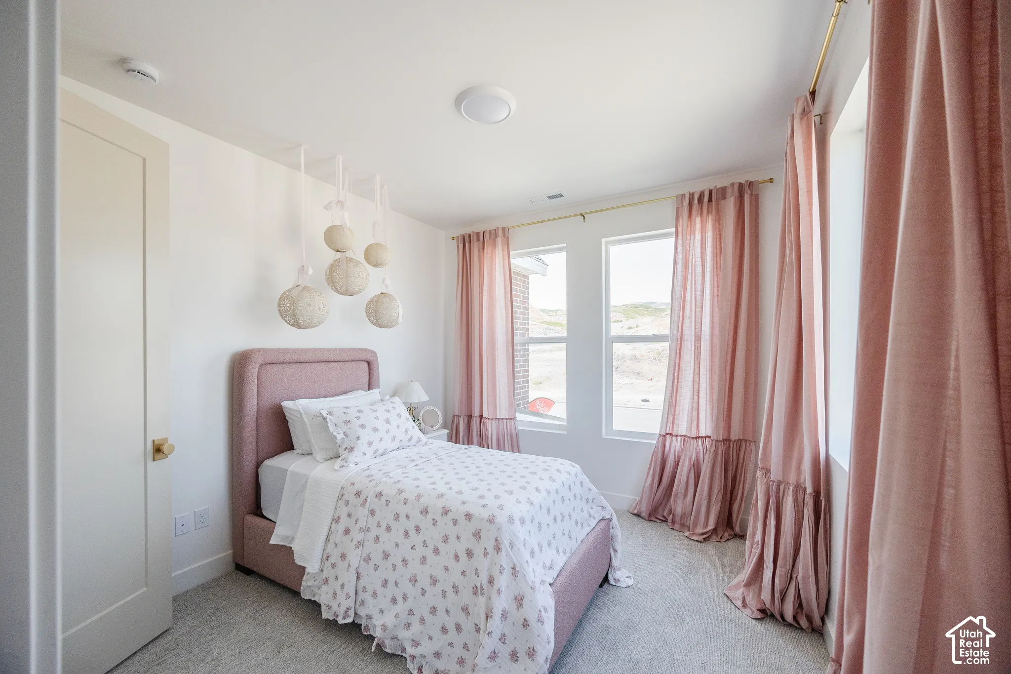 Recessed lighting, wall-to-wall carpeting, multiple windows, and a solid core door with a brass knob