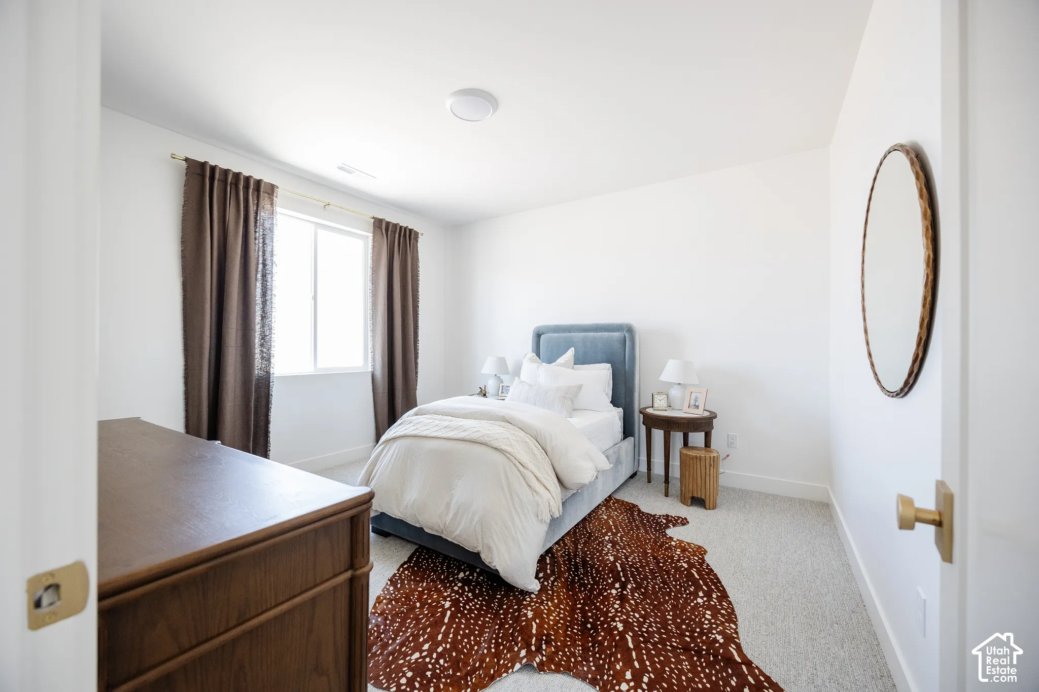 White walls with light-toned carpet flooring