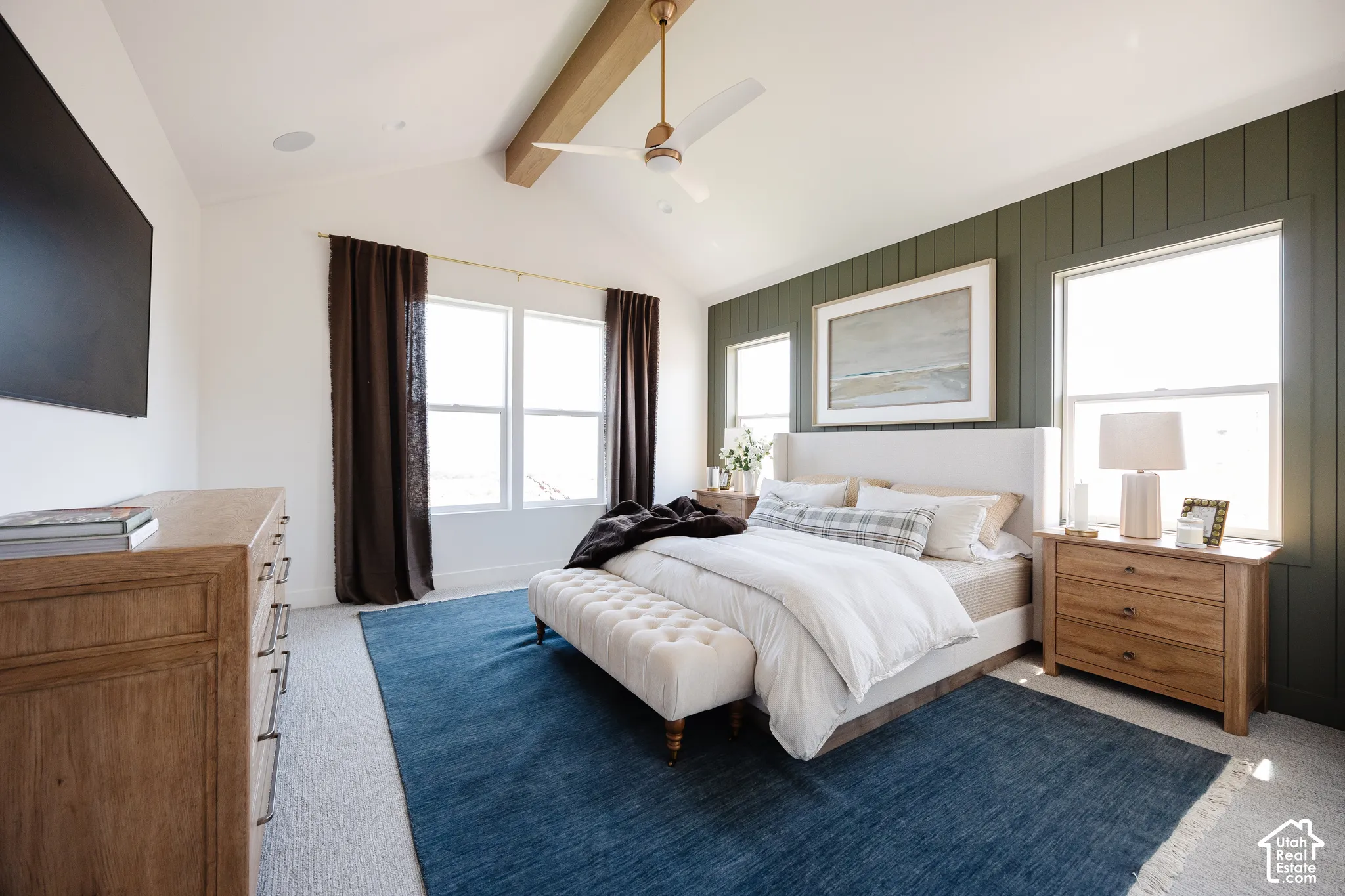 Primary bedroom featuring a wood-frame bed with white bedding, wood-finish nightstands, and recessed ceiling lighting