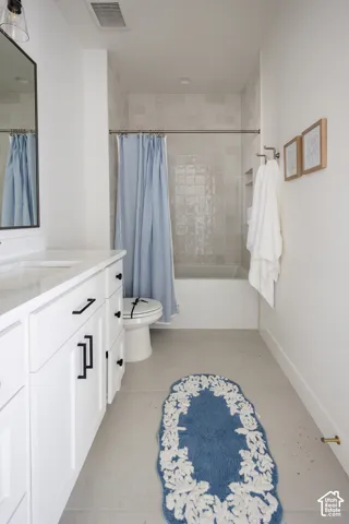 White vanity with black hardware, white countertop, and integrated sink