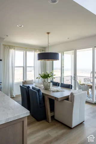 Wood-finish flooring, recessed lighting, and a drum pendant light fixture