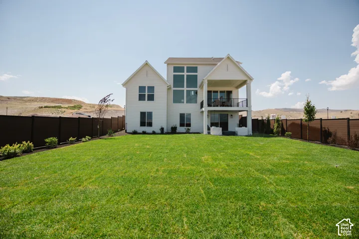 Expansive manicured lawn with a privacy fence