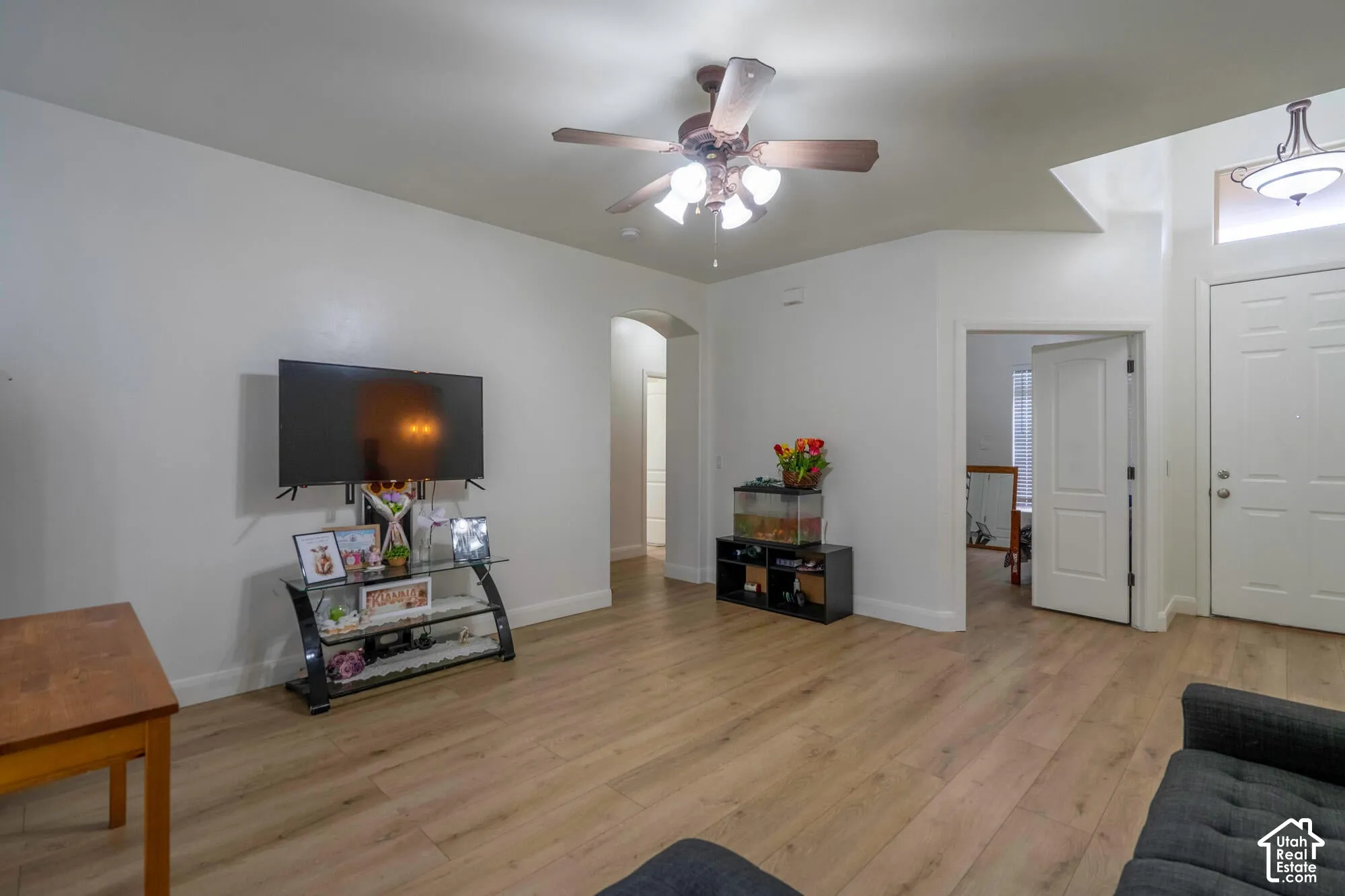 Light wood-finish flooring, recessed lighting, and a ceiling fan with integrated lighting