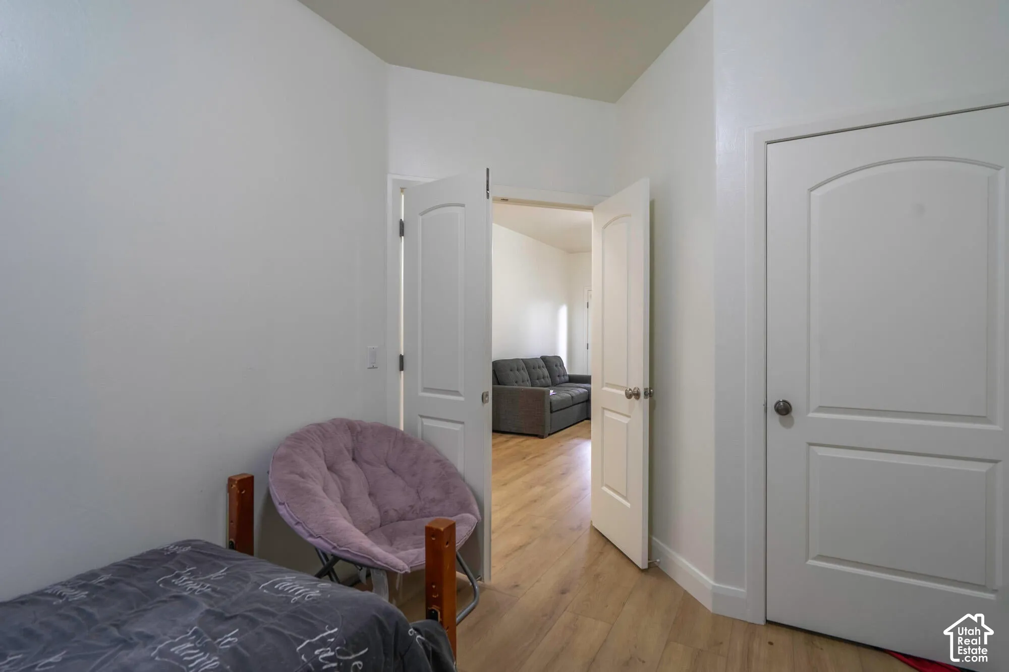Wood-finish flooring throughout, white interior doors, and neutral wall tones