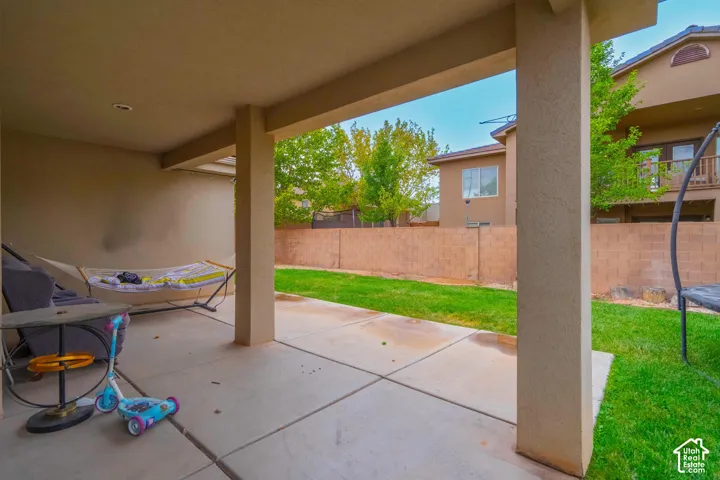 Covered patio featuring concrete flooring and stucco columns