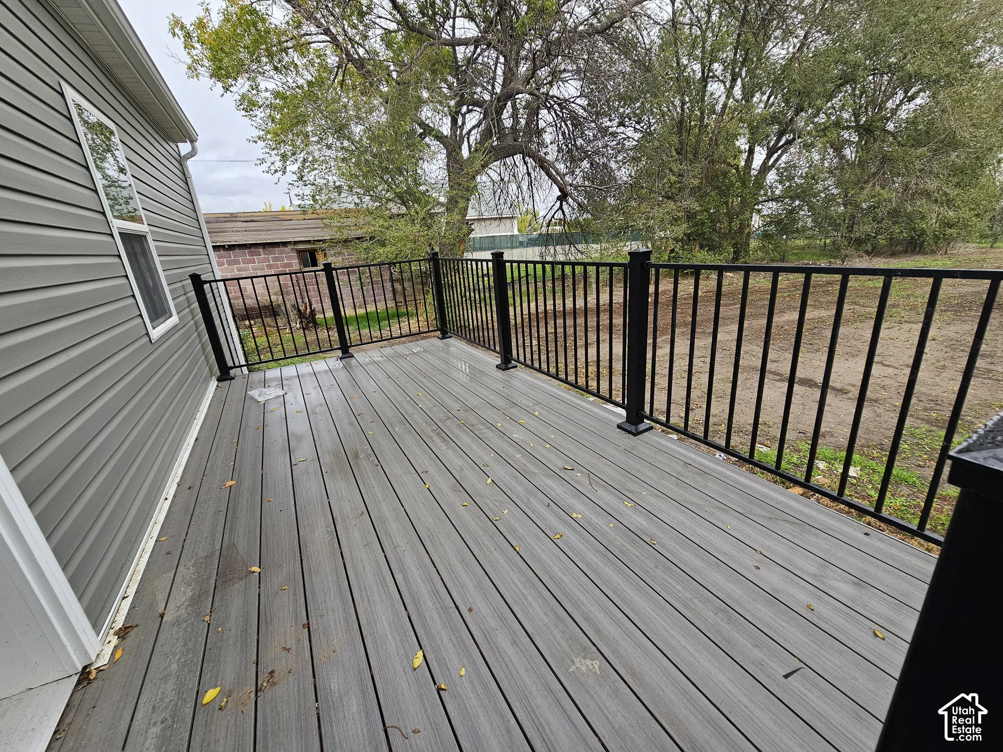 Spacious exterior deck with composite decking and black metal railings
