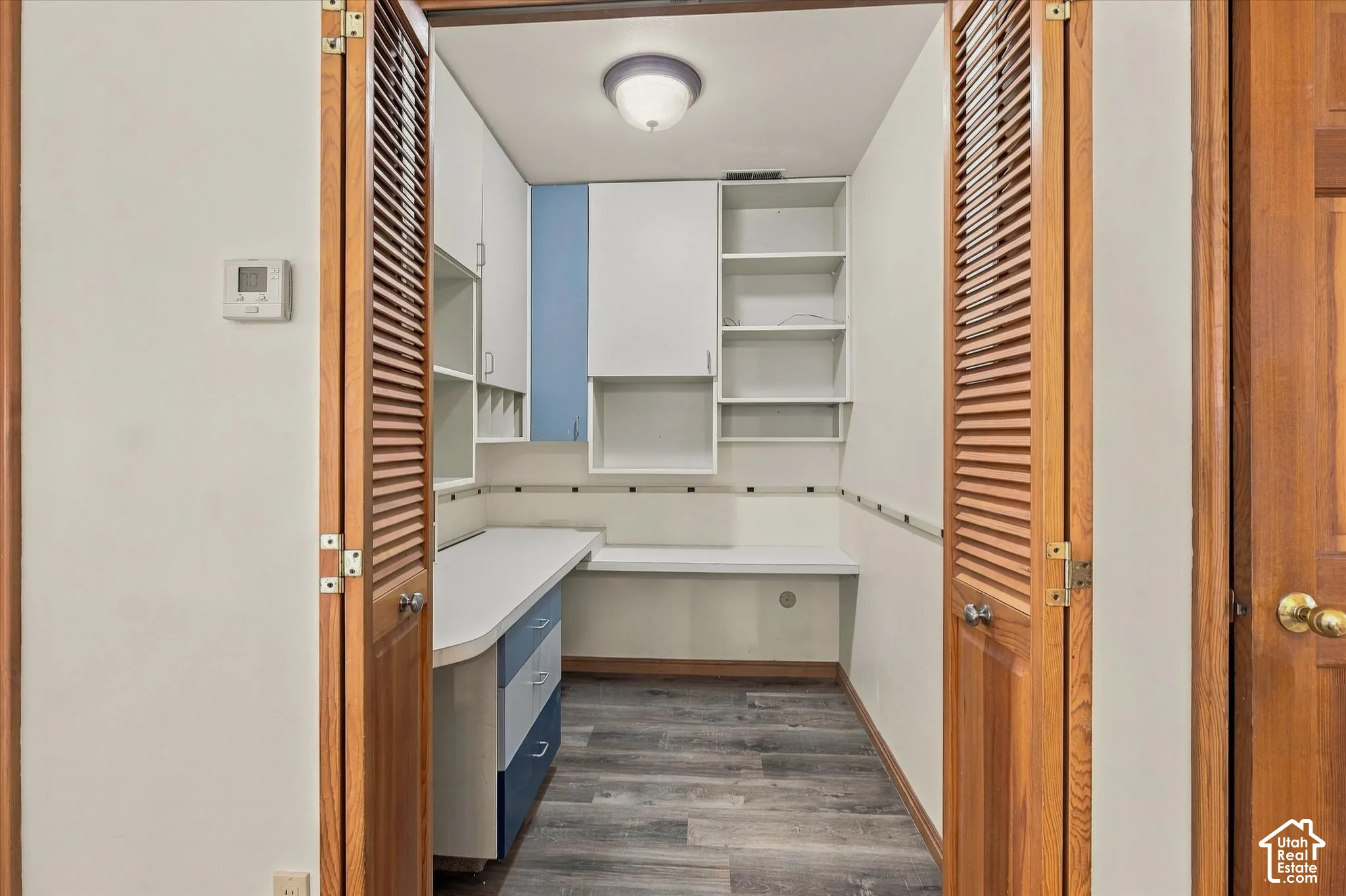 Built-in desk with integrated storage, shelving and extra power outlets.