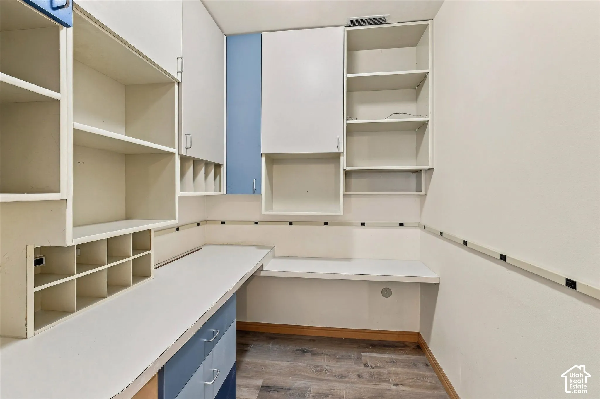 Built-in shelving, integrated desk surfaces, and overhead cabinetry