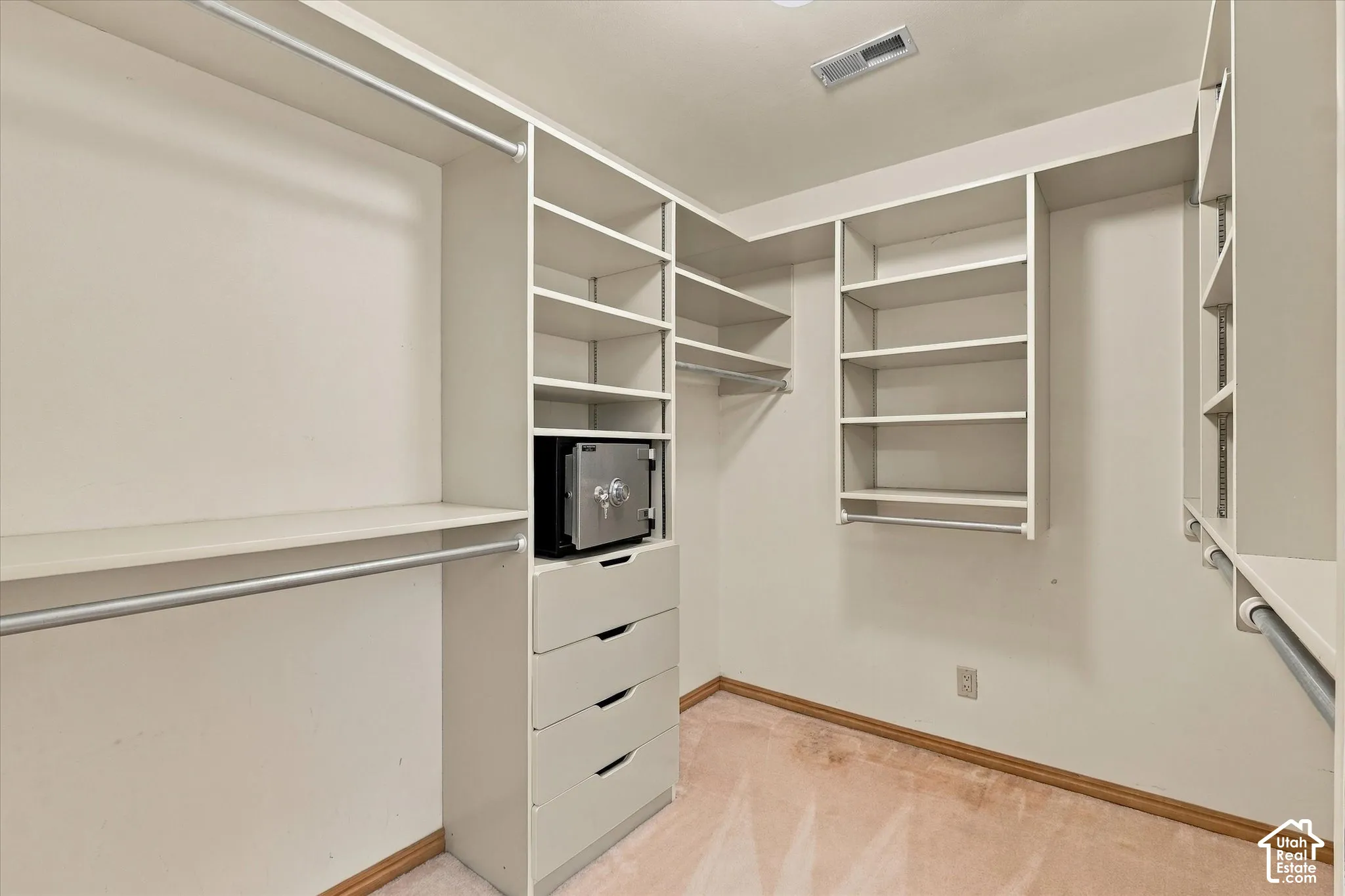 Second custom closet with built-in shelving, integrated drawers, and hanging rods