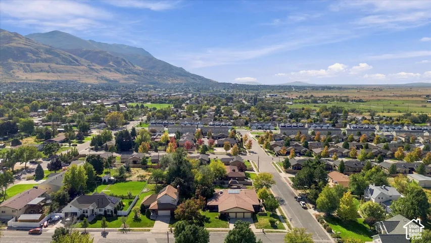 Expansive neighborhood setting with mountain backdrop and residential architecture