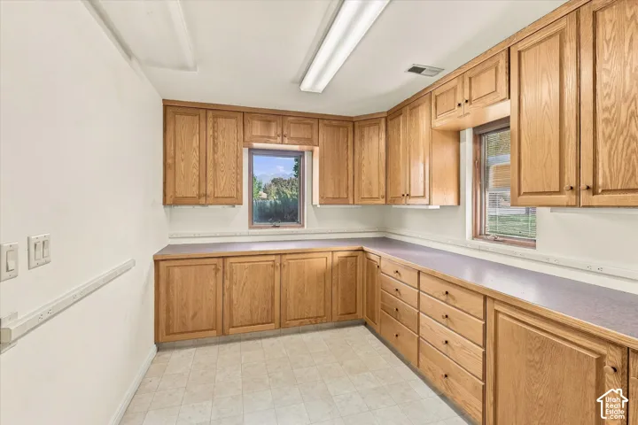 Hobby room with extensive wood cabinetry, ample counter space, multiple outlets and lots of storage drawers