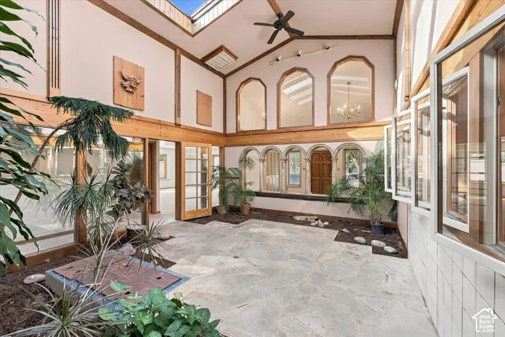 Spacious atrium featuring mature vegetation, stone floor, and skylights