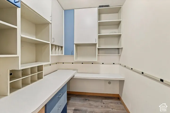 Built-in shelving, integrated desk surfaces, and overhead cabinetry