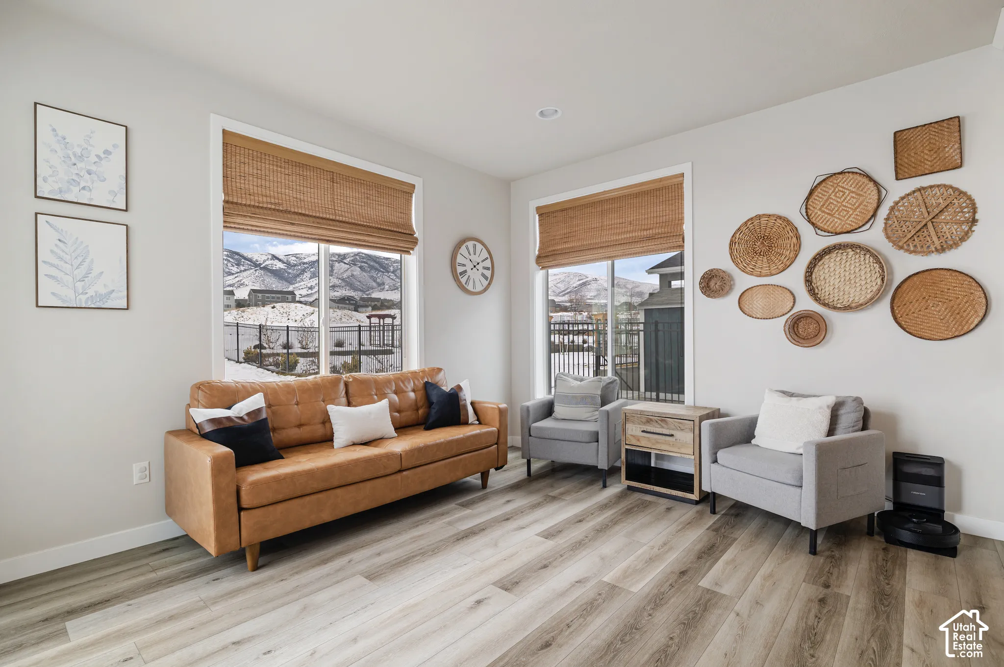 Recessed lighting, wood-finish flooring, and large windows with natural scenery