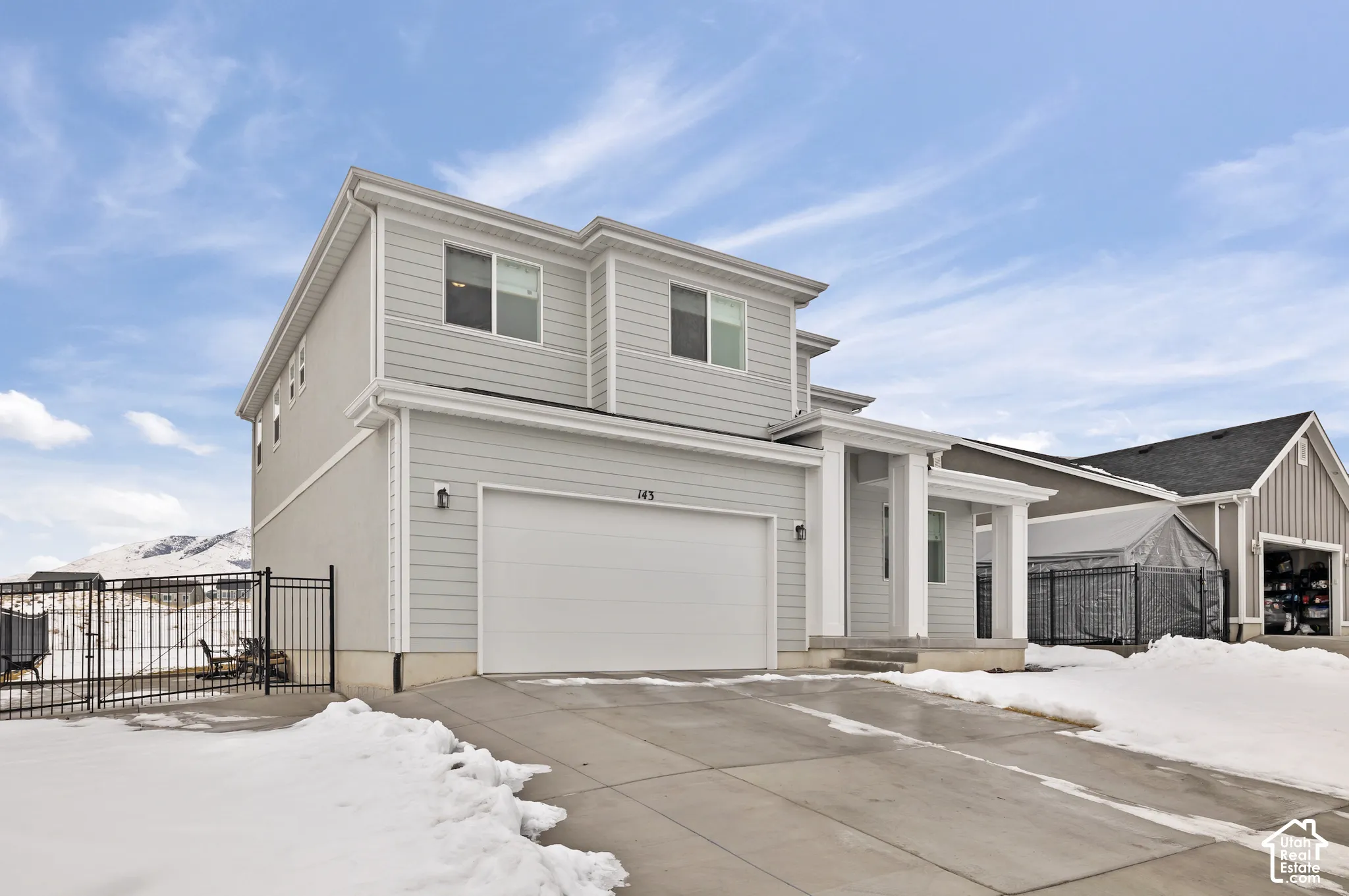 Light gray exterior siding with a two-car garage and concrete driveway