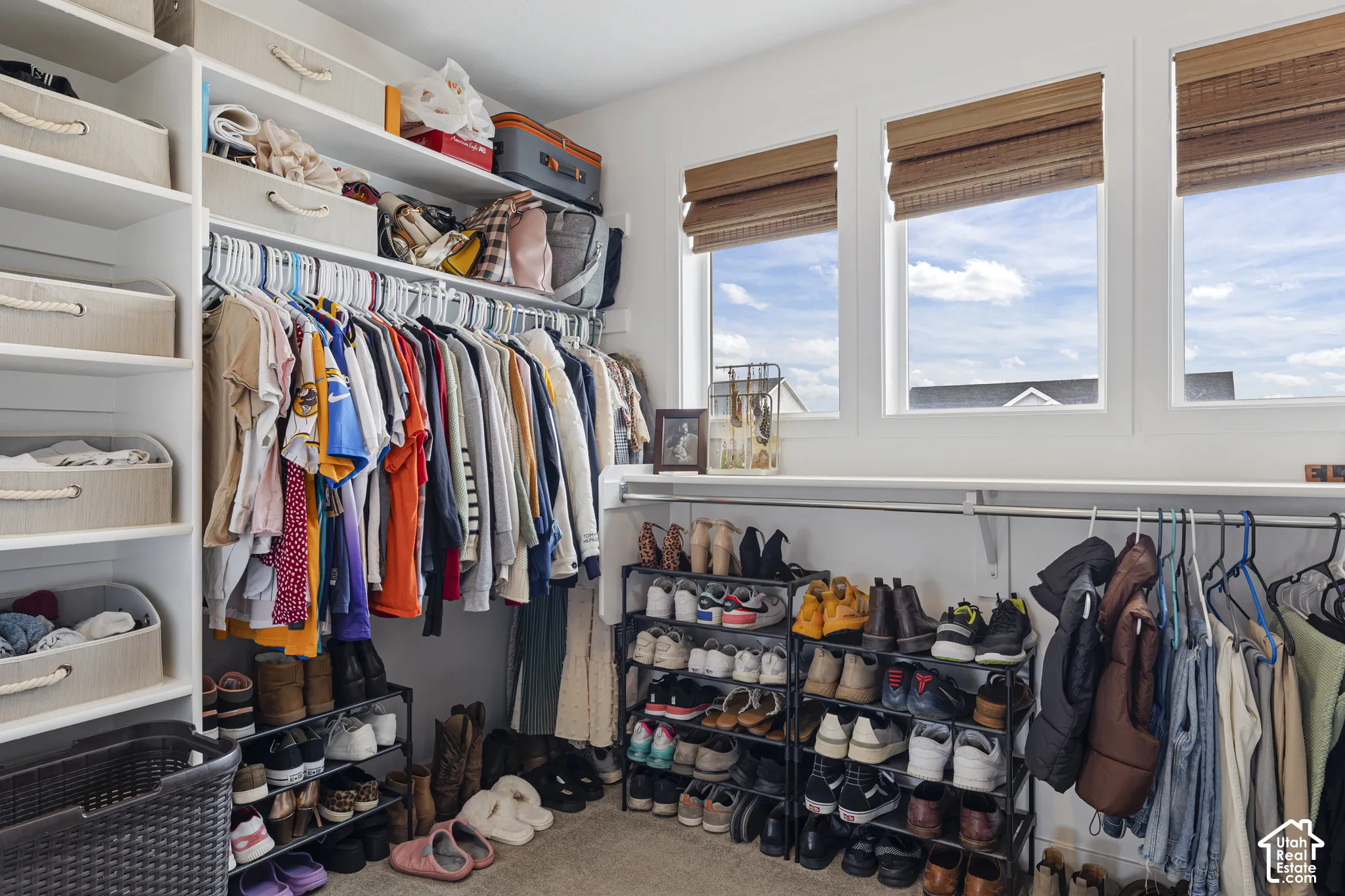 Custom closet organization system with ample shelving and hanging rods