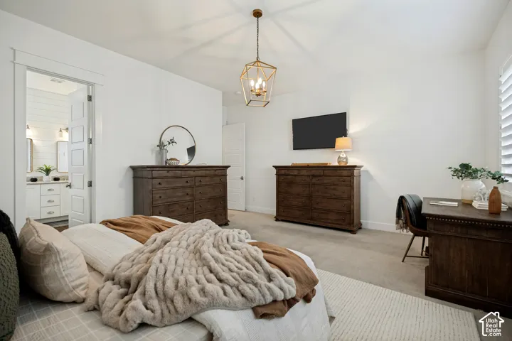 Spacious room featuring neutral carpeting and a decorative ceiling light fixture
