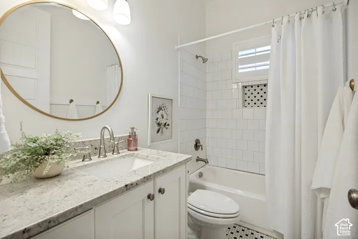 White shaker-style vanity with a light-toned countertop, undermount sink, and brushed nickel faucet