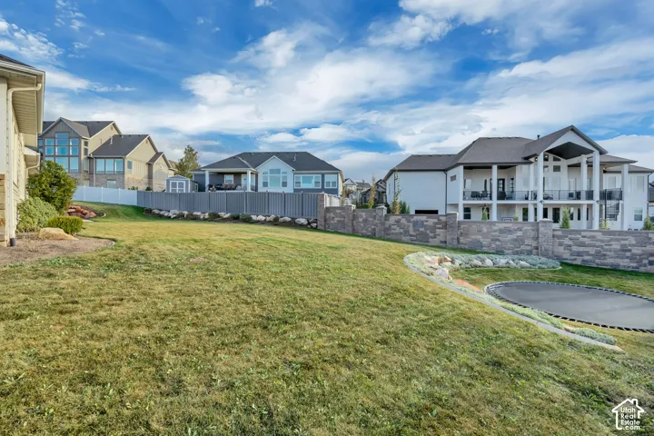 Expansive sloped lawn area with integrated stone retaining walls