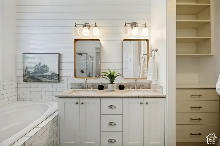 Dual vanity with undermount sinks, stone countertops, and brushed nickel fixtures