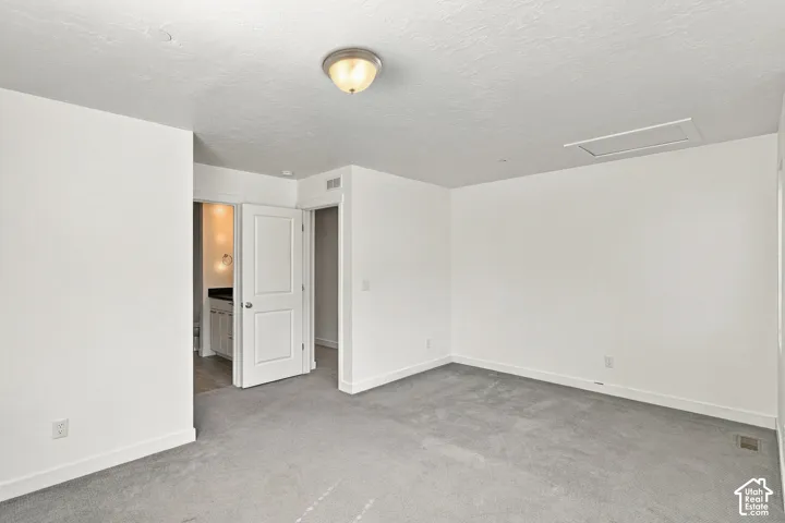 Primary bedroom with Recessed lighting, light gray carpeting, and white trim