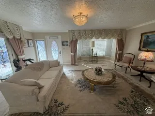 Ceiling-mounted chandelier, decorative bay window, front entry door with leaded glass insert, and side light windows