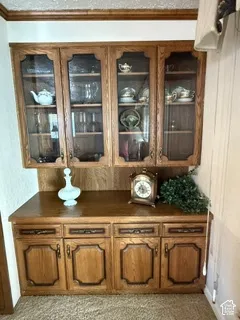 Built-in cabinetry with glass-front upper cabinets and wood-finish lower cabinets