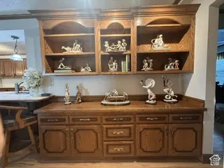Built-in oak cabinetry featuring storage drawers and lower cabinets