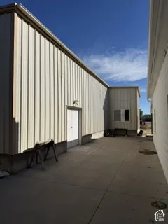 Corrugated metal siding exterior with a white door and small window