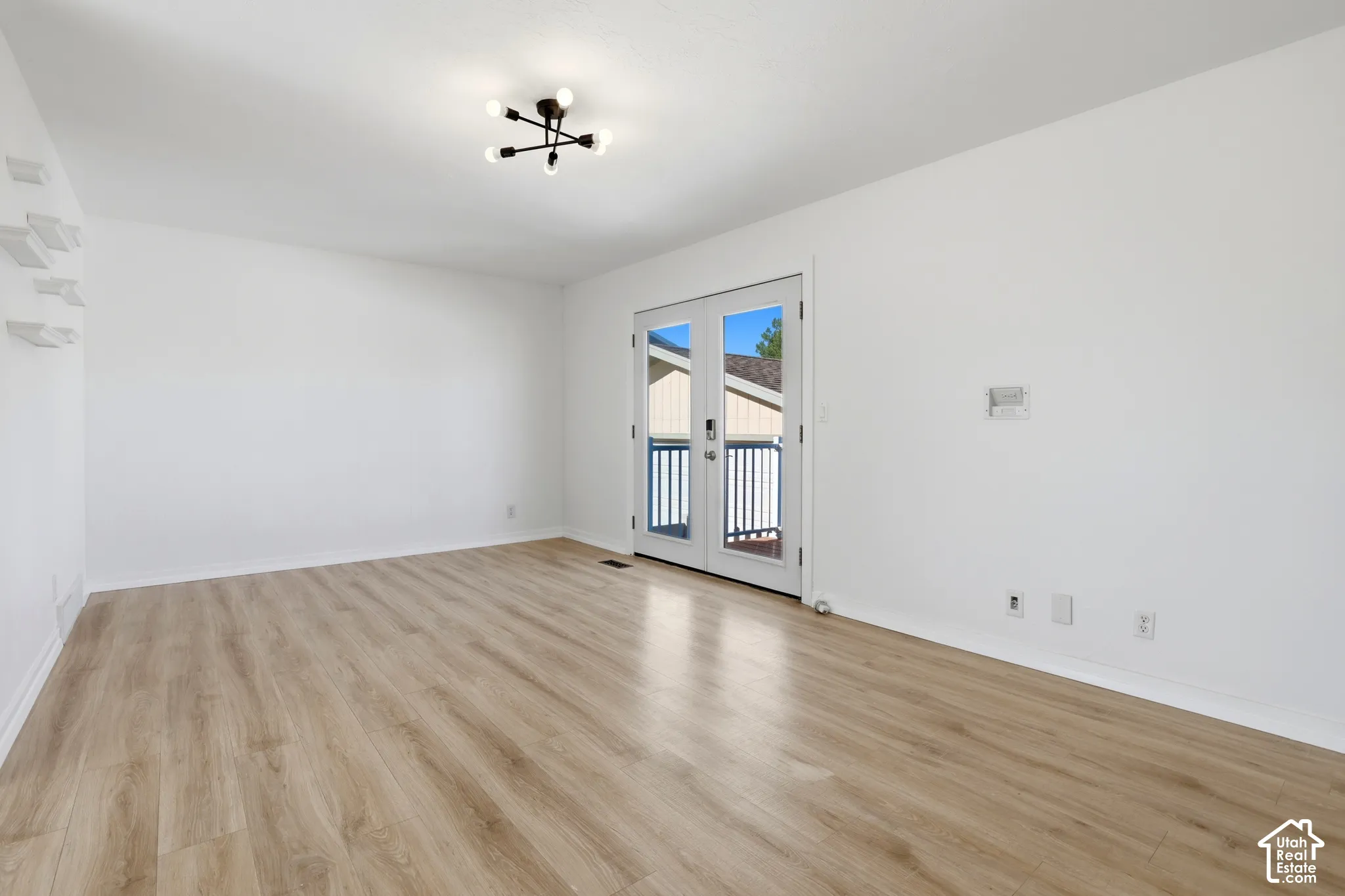 Wood-finish flooring with a modern multi-bulb ceiling fixture